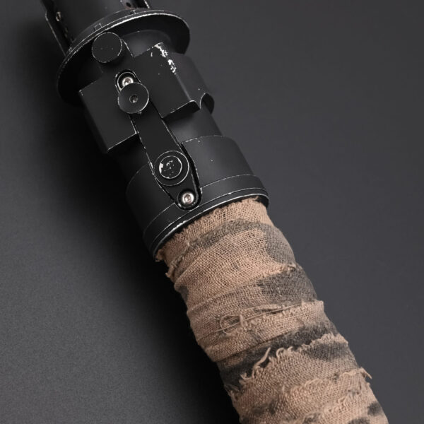 Mid-hilt angle with worn cloth wrapping and utilitarian control section.