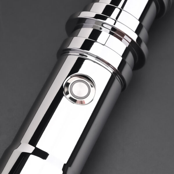 Detailed close-up of black control button on chrome body.