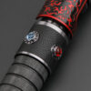 Close-up of the Relic Hunter saber showing dual decorative control buttons on a textured black mid-section.