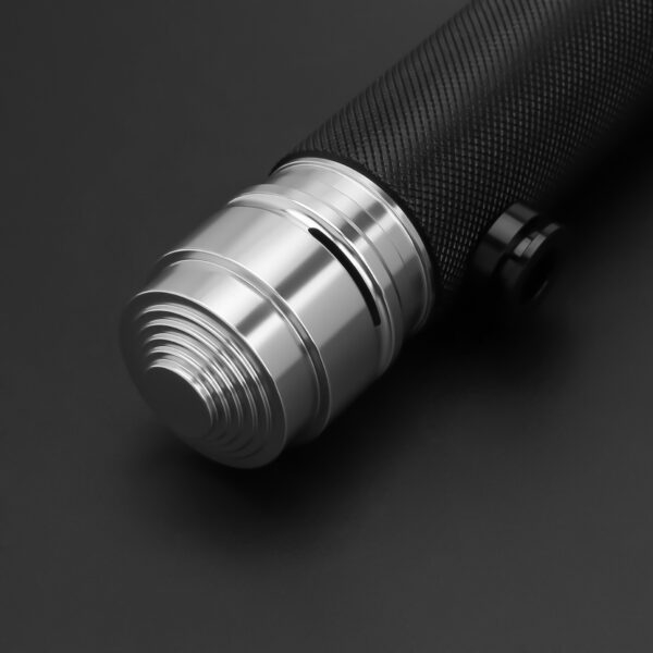 Close-up of Survivor SE pommel with polished silver grooves and textured black grip.