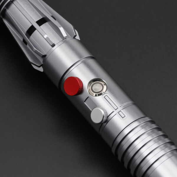 Close-up of Shadow Hunter SE hilt section showing red activation switch and silver detailing.