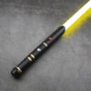 Black T Guard SE (Single) saber with gold accents and yellow blade on gray background.